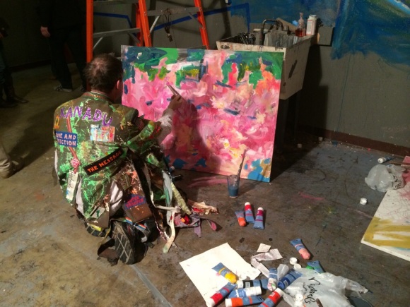 Artist Adam Kemp works on a painting during ArtSee.